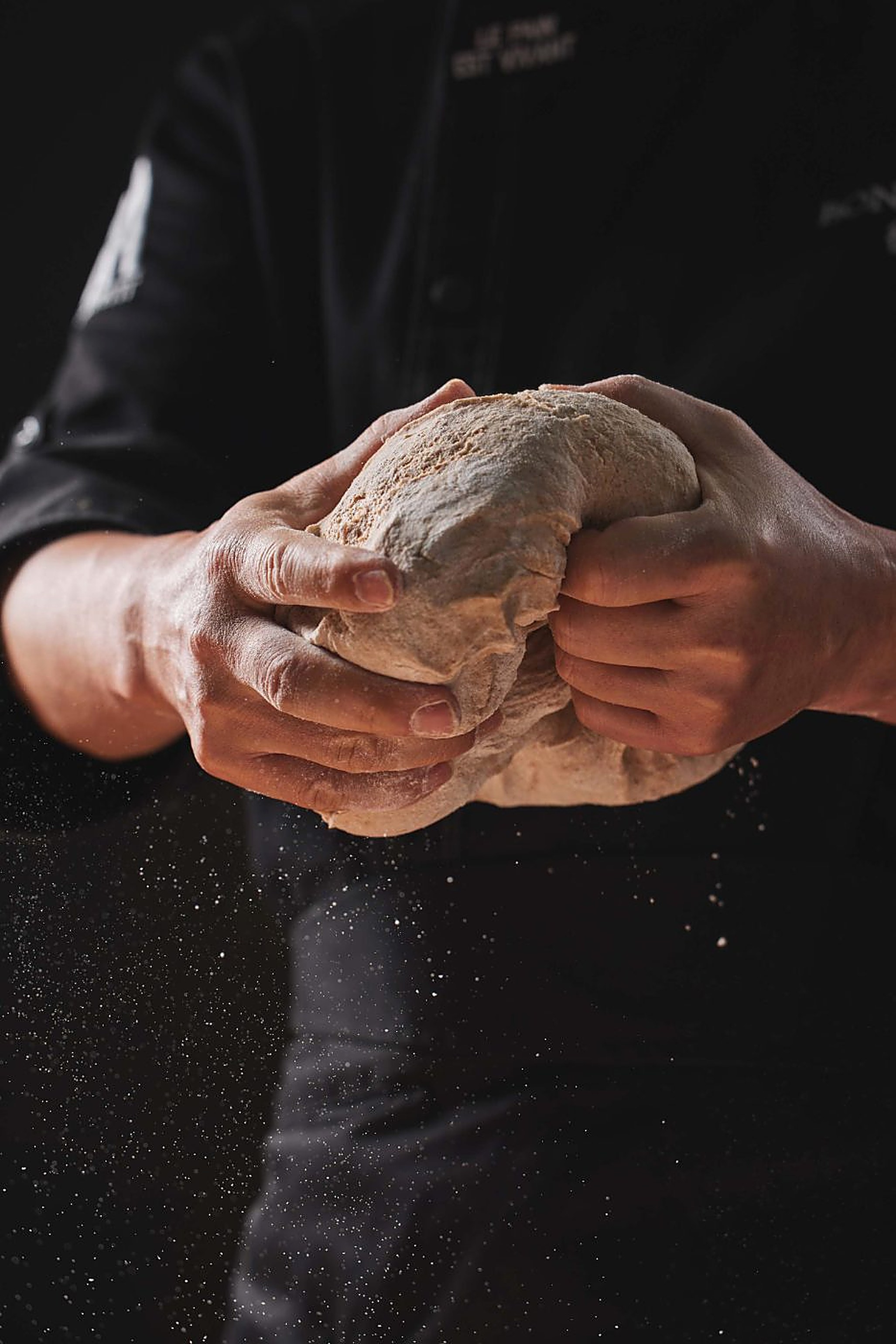 Hands folding a round of living sourdough